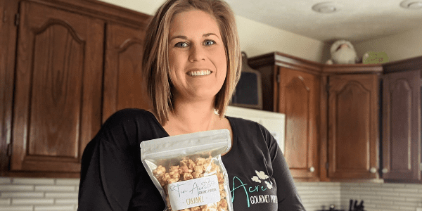 Abby Balster holds a bag of Tin Acre Gourmet Popcorn in her New Bremen, Ohio, home.